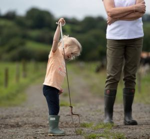 A farmers' young daughter hard at work on farm.