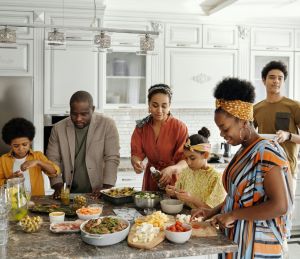 A group of adults and children tucking into a delicious meal.