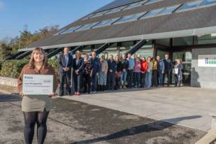 One of the Lakeland Dairies bursary winners stood in front of a group outside Lakeland Dairies HQ in Killygarry.