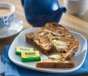 Lakeland Dairies Salted butter portions on a plate next to slices of toast