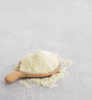 Fat filled milk powder on wooden spoon