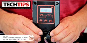 Man holding black product with red buttons