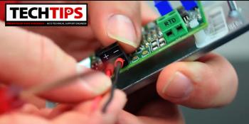 Man connecting wires to circuit board