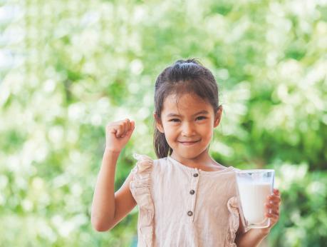 Girl holding glass of milk