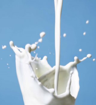Milk pouring downwards, created a large splash