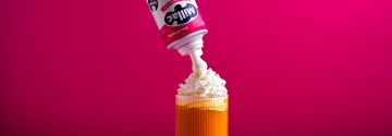 Millac Roselle aerosol can squirting cream onto a beverage