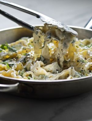 Saucepan with creamy pasta noodles and chicken