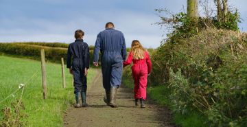 One of the Lakeland Dairies milk suppliers with his two children on his farm.