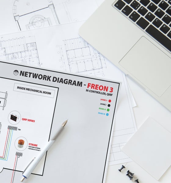 Scattered papers a pen and a laptop