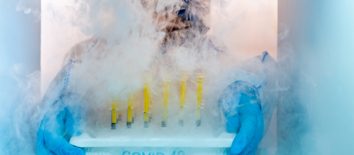 Man holding tubes in a freezer